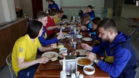 The Ukrainian swim team sits down to eat a meal together at Kasımpaşa SK football club.