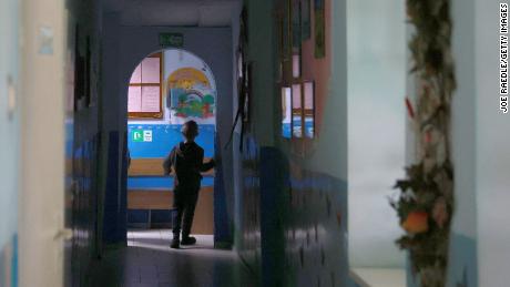 A child walks down a hallway in an orphanage in Lviv, Ukraine, that houses 40 children ages 3 to 18. Lviv has served as a stopover and shelter for Ukrainians fleeing the Russian invasion, either to the safety of nearby countries or the relative security of western Ukraine.