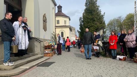 A priest reminds parishioners of Jesus&#39; sacrifice from the steps of the Church of the Intercession of the Blessed Virgin in Lviv, Ukraine on April 23, 2022. 