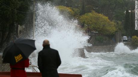 People watch the waves in Volosko, Croatia, on October 29, 2018. 