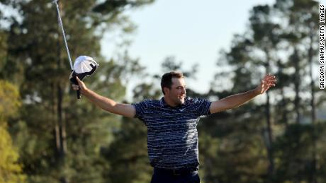 Scheffler celebrates on the 18th green after winning the Masters.