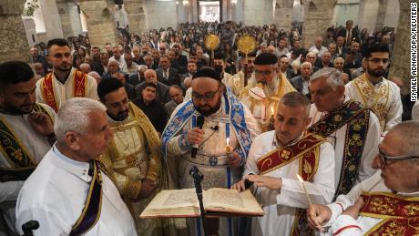 Priests lead the Easter Mass of Syriac Orthodox Christians on Sunday at Mart Shmoni Church in Bartella, east of Mosul, northern Iraq. 