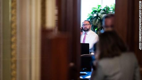 Jason Miller talks on the phone in a meeting room for lawyers of former President Donald Trump during his Senate Impeachment trial on Capitol Hill, February 12, 2021