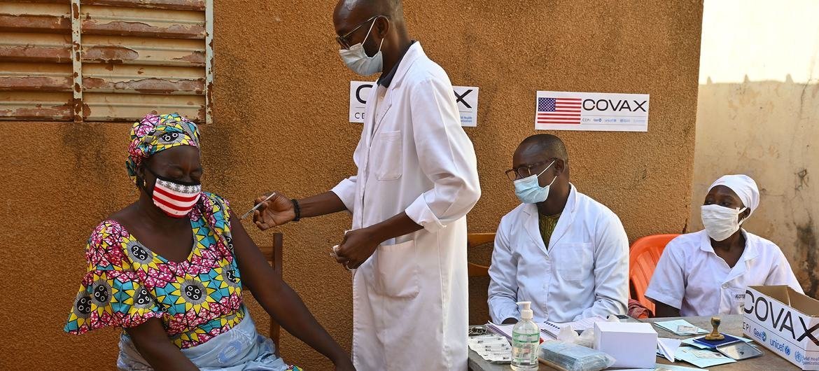 A mother receives her second dose of the COVID-19 vaccination at a health centre in Obassin, Burkina Faso.