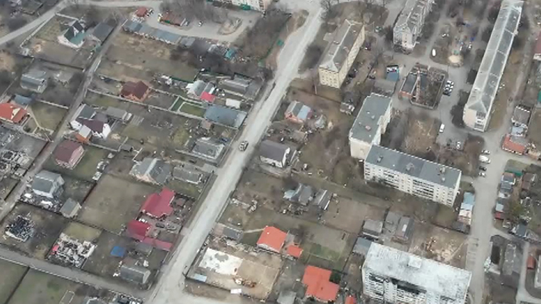 New drone video shows Russian military vehicles and forces on Bucha street strewn with civilian bodies