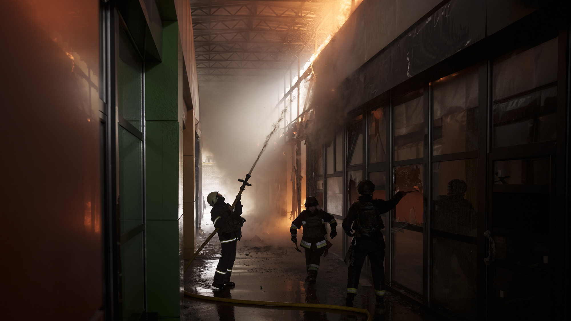 Firefighters work to extinguish a fire at a shop following a Russian bombardment in Kharkiv, Ukraine on Friday April 22.