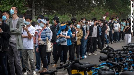 People line up for Covid tests at a makeshift testing site in Beijing&#39;s Chaoyang district on Monday.