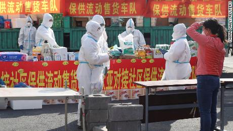 Health workers stand inside a residential compound in Changchun, China, on April 19.