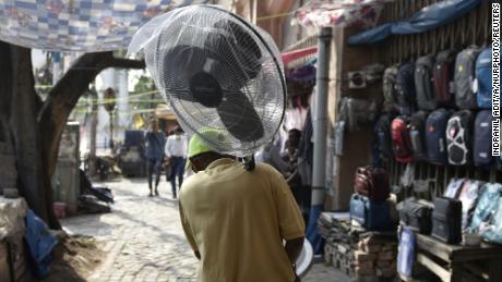 A man carries a fan during a heat wave in Kolkata, India.