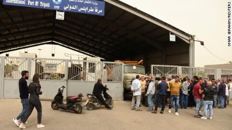 Relatives of those who died when a boat capsized coast gather at the port of Tripoli, northern Lebanon, on April 24, 2022.