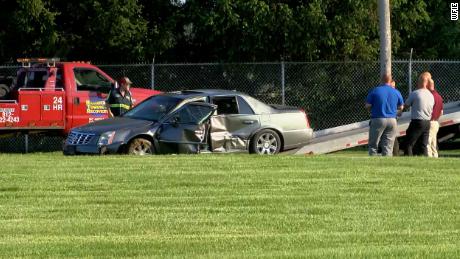 The damaged Cadillac sits at the scene where the chase ended.