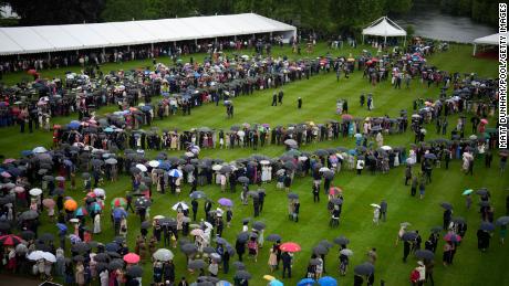 Guests brave the weather during a Royal Garden Party at Buckingham Palace on Wednesday.