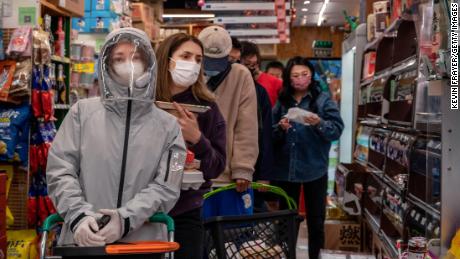 People wait in long lines at a supermarket on May 12 in Beijing, China.