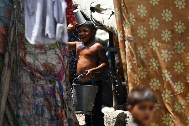 A boy takes a bath during the heatwave