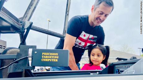 Lekiachvili helps a child check out the starfighter&#39;s features. 