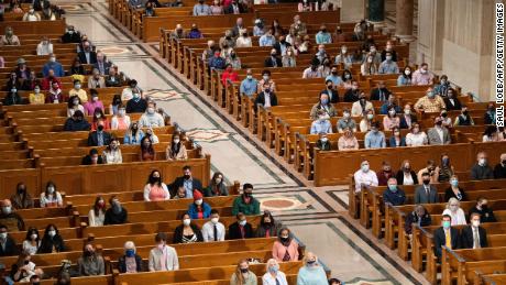 People attend Easter Sunday Mass at the Basilica of the National Shrine of the Immaculate Conception in Washington, DC on April 4, 2021. 