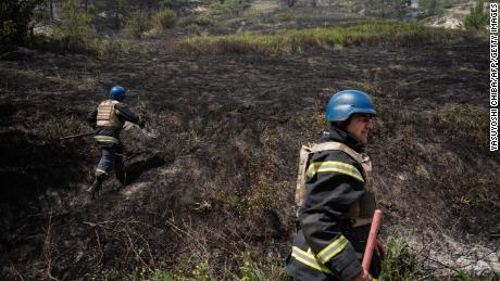 Ukrainian attempt to extinguish a fire caused by shelling in Sydorove, in eastern Ukraine, on May 17, 2022.