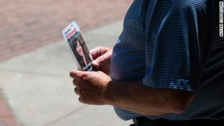 A person holds a campaign flyer for Strahan in Rome on May 12, 2022.