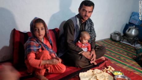 Waliullah and his family sit down for dinner in their home on the outskirts of Kabul.