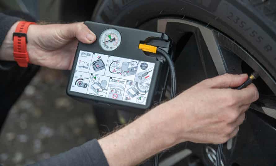 Closeup of person checking tyre pressure