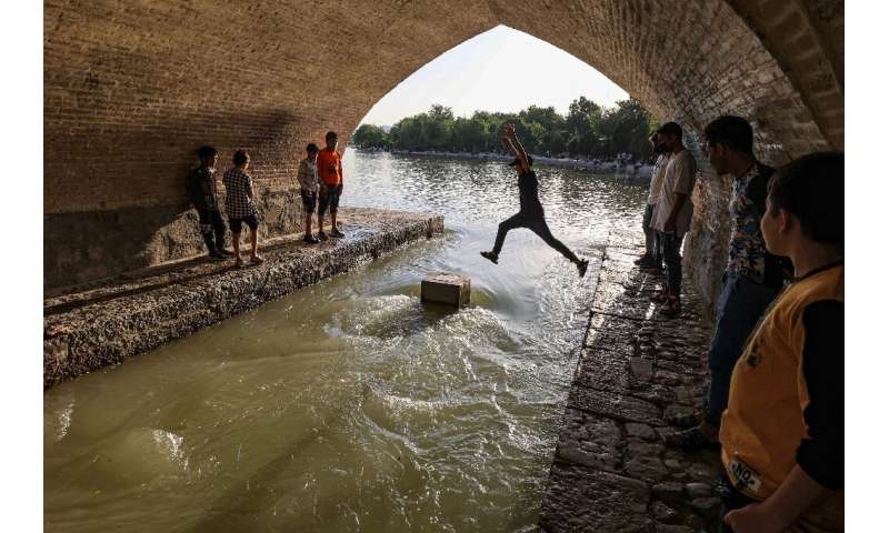 A boy jumps across one of the arches of the 295-metre-long Si-o-Se Pol (33 arches) bridge