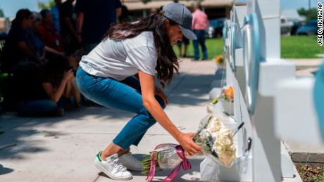 Meghan, Duchess of Sussex leaves flowers at the memorial site.