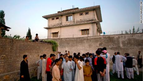 Residents gather outside a house, where al Qaeda leader Osama bin Laden was caught and killed in Abbottabad, Pakistan on May 3, 2011.