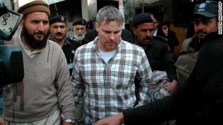 Pakistani security officials escort Raymond Davis, center, to a court in Lahore on January 28, 2011.