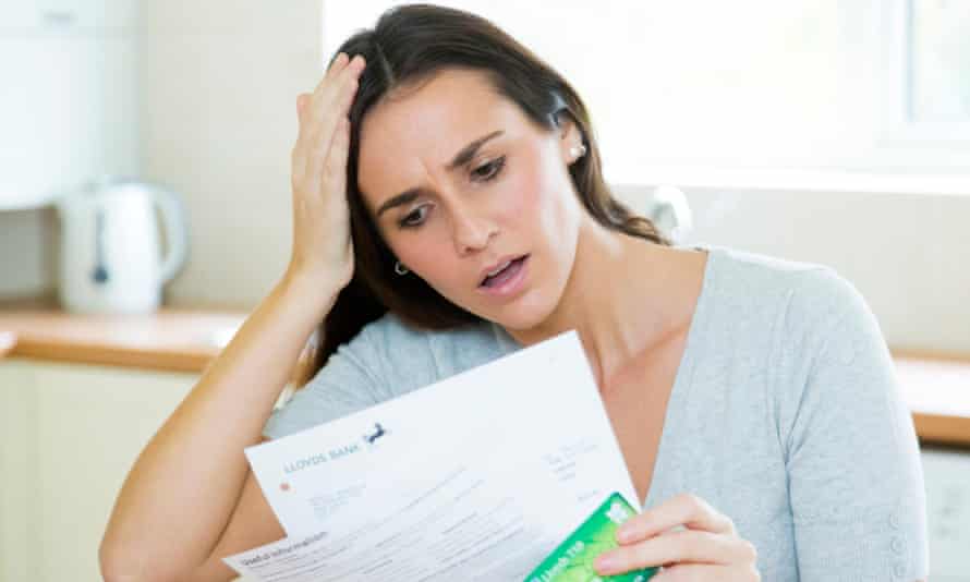 Worried woman looking at bank statement