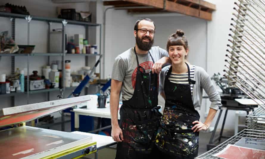 Two silk screen workers showing their workshop