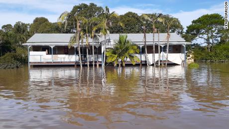 The water was high enough for Ken Morrison and his family to climb over the second balcony into his boat.