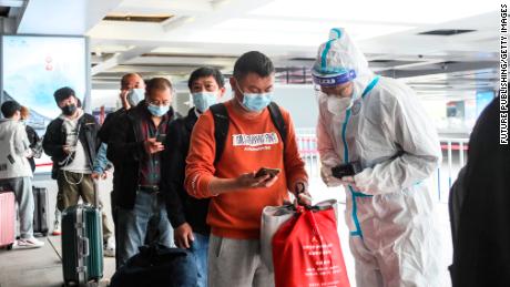 Covid workers check the travel information of passengers at a high-speed railway station in Huai &#39;an, China, on May 11.