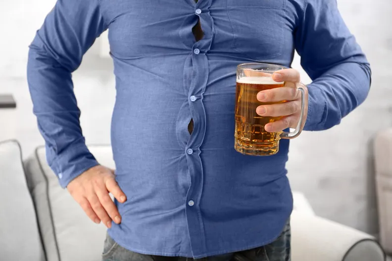 Overweight Man Drinking Beer