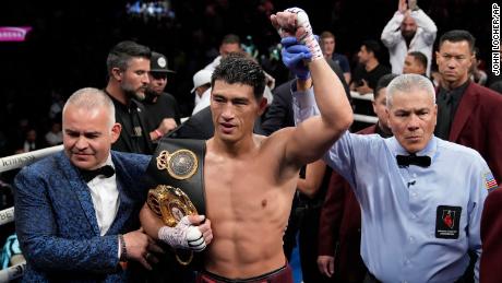 Bivol celebrates after beating Alvarez in their light heavyweight title match.