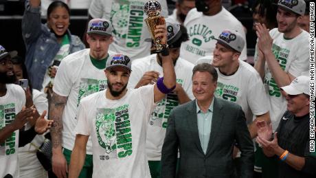 Jayson Tatum holds aloft the inaugural Larry Bird MVP trophy.