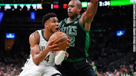 &#39;The Greek Freak&#39; drives the ball against Celtics center Al Horford.