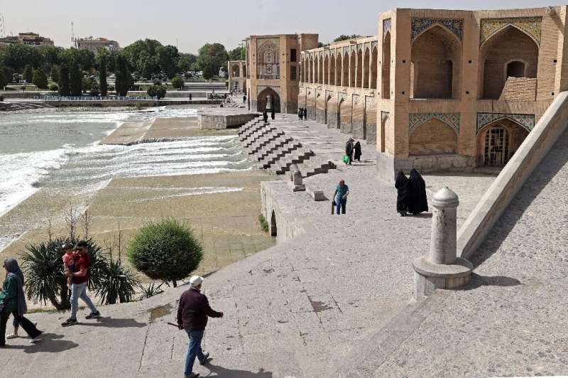 Iranians gather on the iconic Khaju Bridge over the Zayandeh Rud river in Isfahan, on May 16, 2022