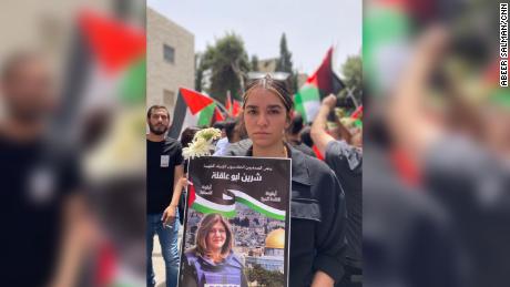 Shireen Abu Akleh&#39;s niece, Lareen, 19,  at her aunt&#39;s funeral procession in Jerusalem. Her poster reads: &quot;Shireen Abu Akleh, an icon of journalism and of free speech&quot;. Lareen is an aspiring journalist. 