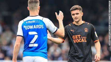 Daniels shakes hands with Ronnie Edwards of Peterborough United after a game in Peterborough.