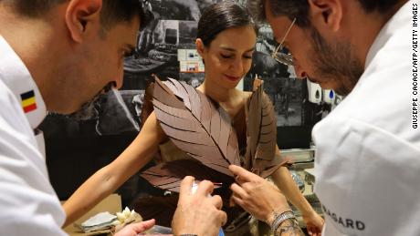 Chocolatiers add the last touches to a dress made of chocolate, during a fashion show at the first Salon du Chocolat Dubai fair, organized in the emirate, on May 12. 