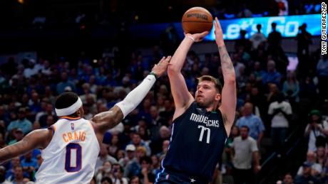 Doncic shoots over Phoenix Suns forward Torrey Craig.