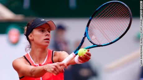 Linette serves against Jabeur in their first round match during the 2022 French Open.