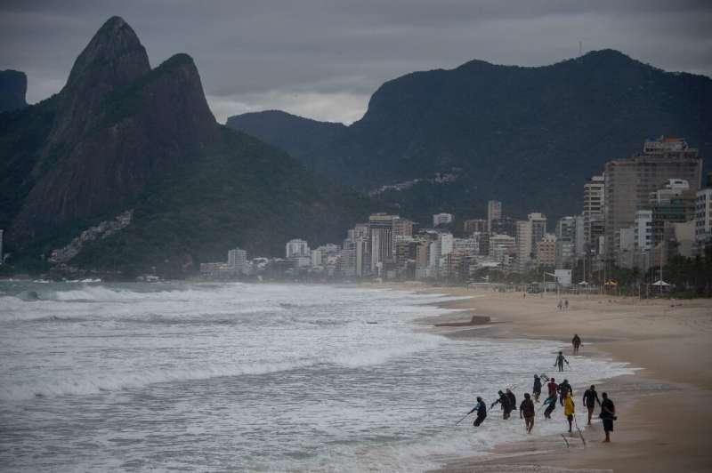 People are seen at Ipanema Beach in Rio de Janeiro, Brazil, on May 19, 2022, during an unusual cold snap affecting the center an