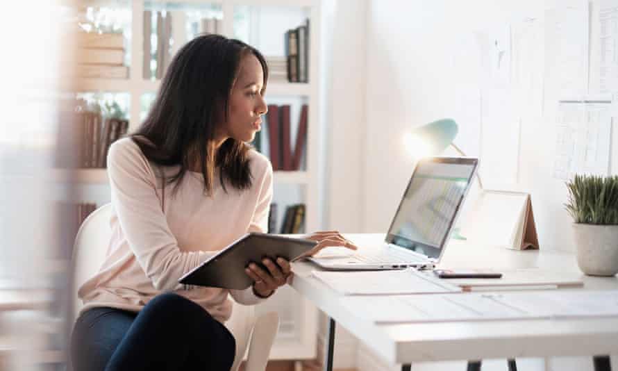 Businesswoman sitting at desk using laptop