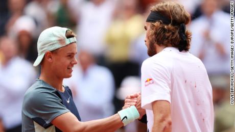 Rune and Tsitsipas meet at the net following their French Open quarterfinal. 