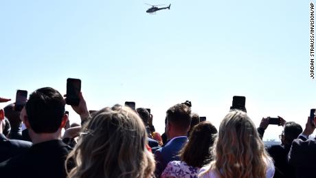 Attendees look on as Tom Cruise arrives in a helicopter to the world premiere of &quot;Top Gun: Maverick&quot; on Wednesday, May 4, 2022, at the USS Midway in San Diego. (Photo by Jordan Strauss/Invision/AP)