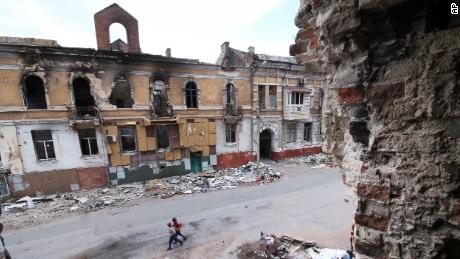 Children walk among buildings destroyed during fighting in Mariupol, in territory under the government of the Donetsk People&#39;s Republic, eastern Ukraine, Wednesday, May 25, 2022. 