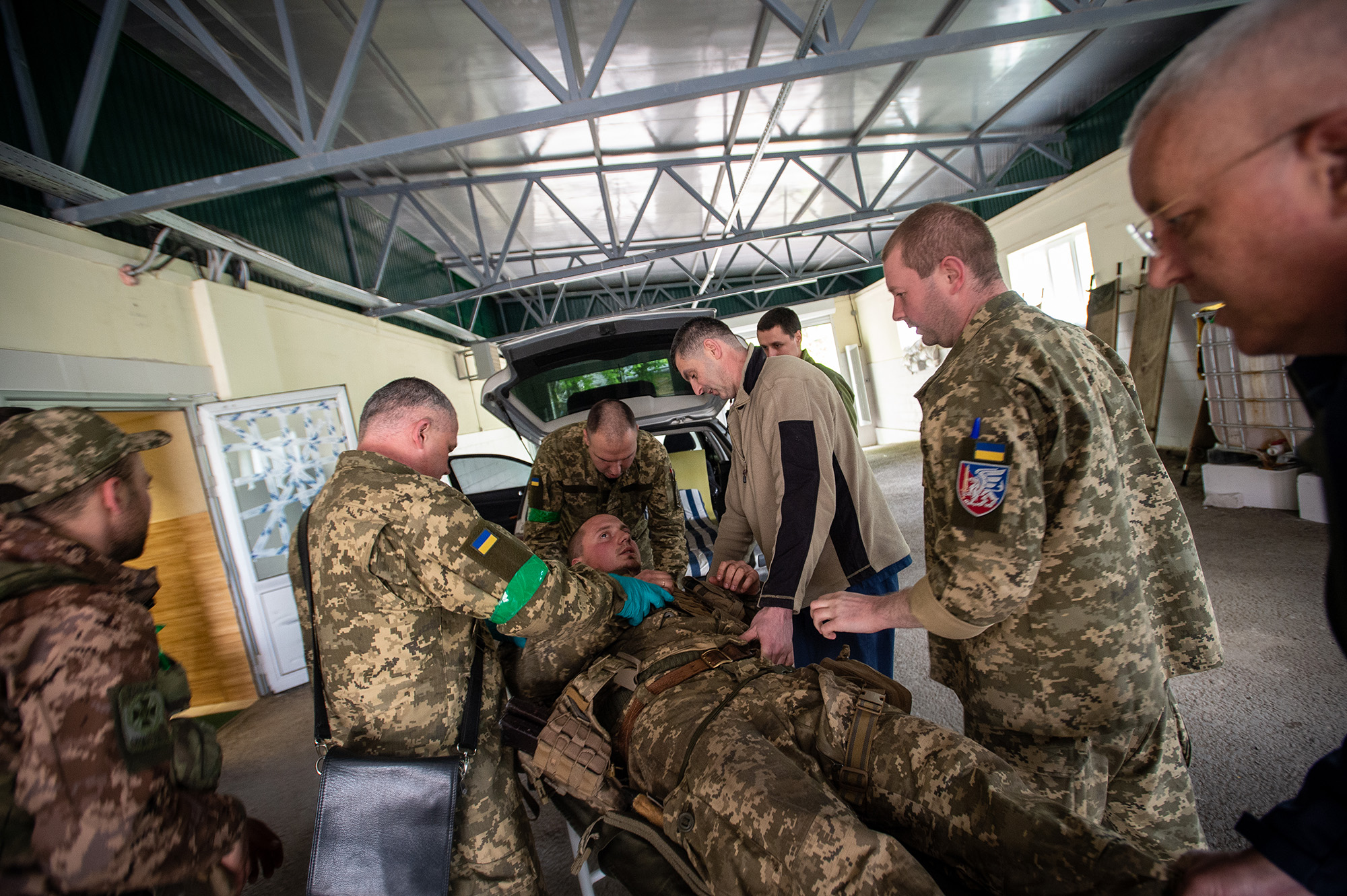 Ukrainian Army medical units unload a shell-shocked and concussed soldier at a medical facility in Kramatorsk, Ukraine, on April 29.