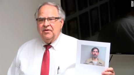 Lauderdale County Sheriff Rick Singleton holds a picture of Casey White.