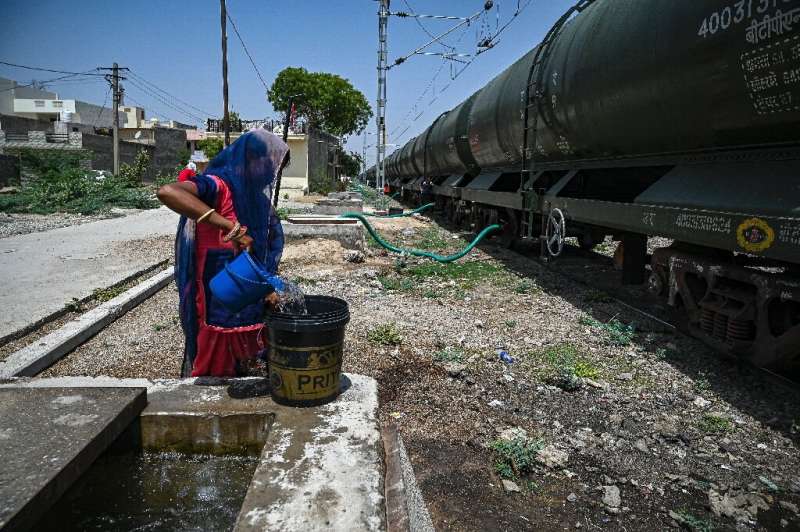 Every day dozens of villagers in a parched corner of India's Rajasthan state wait for hours a day for a special train delivering